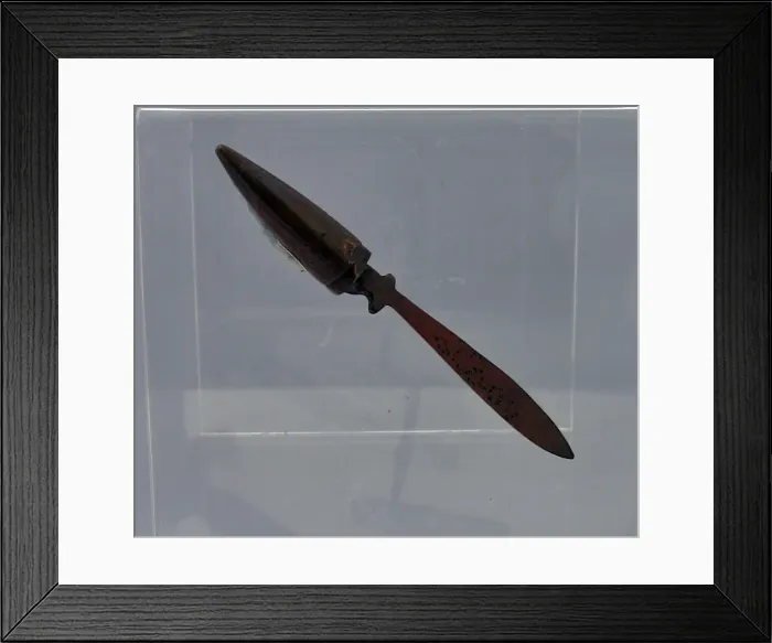 Framed Print : A tiny letter opener beaten from a copper bullet Framed Print : A tiny letter opener beaten from a copper bullet