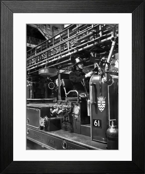 Framed Print : Firefighter at the wheel of a fire engine Framed Print : Firefighter at the wheel of a fire engine