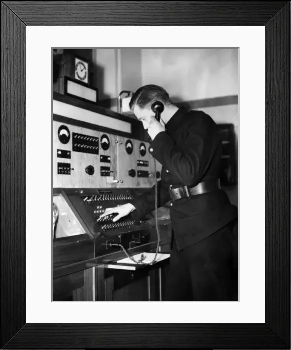 Framed Print : Man taking a call in a fire station control room Framed Print : Man taking a call in a fire station control room