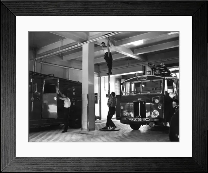 Framed Print : London firefighters sliding down a pole Framed Print : London firefighters sliding down a pole