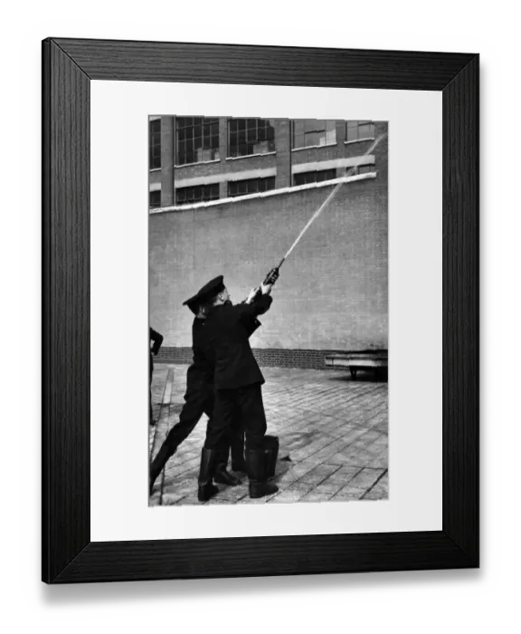 Framed Print : LFB firefighters using a hand squirt Framed Print : LFB firefighters using a hand squirt