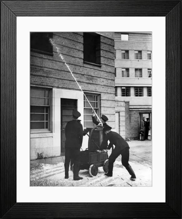 Framed Print : Firefighters operating old pump at special drill display Framed Print : Firefighters operating old pump at special drill display