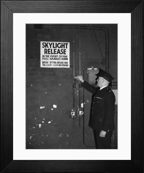 Framed Print : Fire prevention officer checking skylight release Framed Print : Fire prevention officer checking skylight release