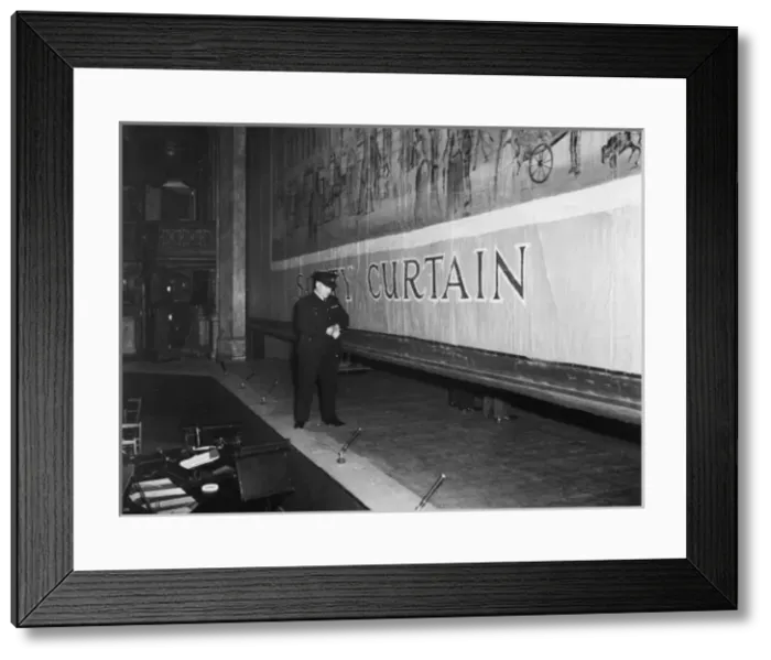 Framed Print : Fire prevention officer checking safety curtain Framed Print : Fire prevention officer checking safety curtain