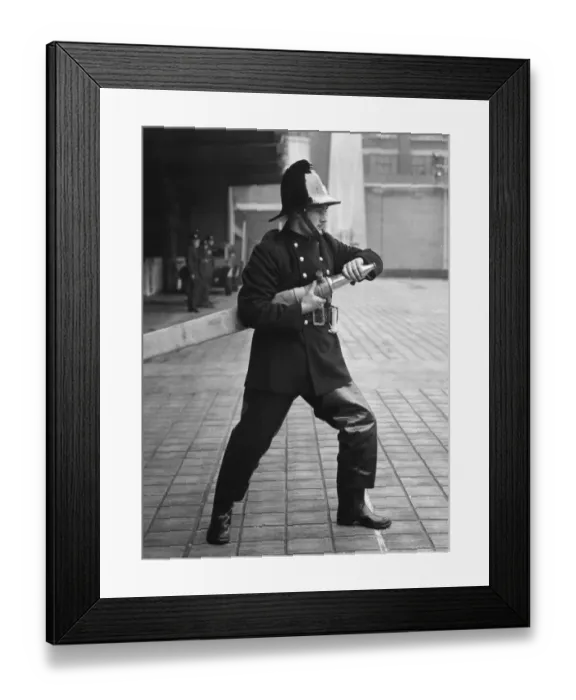 Framed Print : Firefighter taking part in a hose training drill Framed Print : Firefighter taking part in a hose training drill