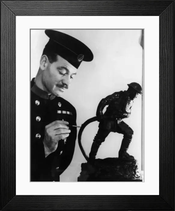 Framed Print : Firefighter painting statuette of fireman in action Framed Print : Firefighter painting statuette of fireman in action