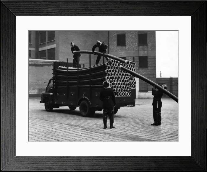 Framed Print : LFB firefighters unloading piping from a vehicle Framed Print : LFB firefighters unloading piping from a vehicle