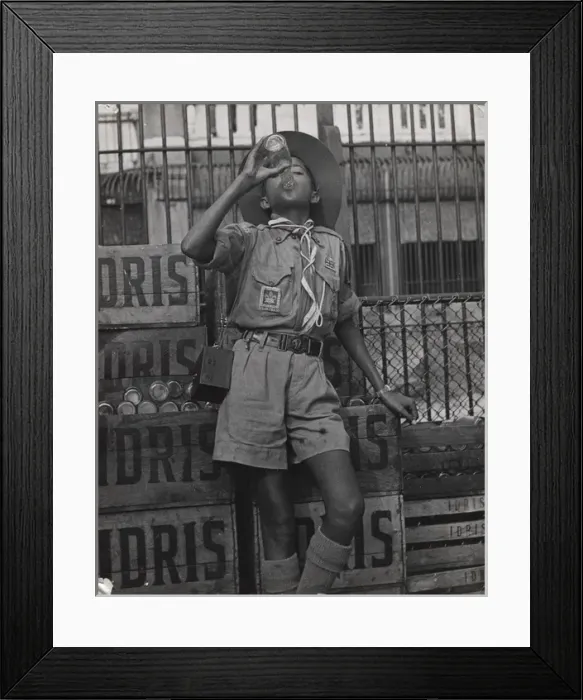 Framed Print : Boy scout drinking from a bottle of Idris, Mauritius Framed Print : Boy scout drinking from a bottle of Idris, Mauritius