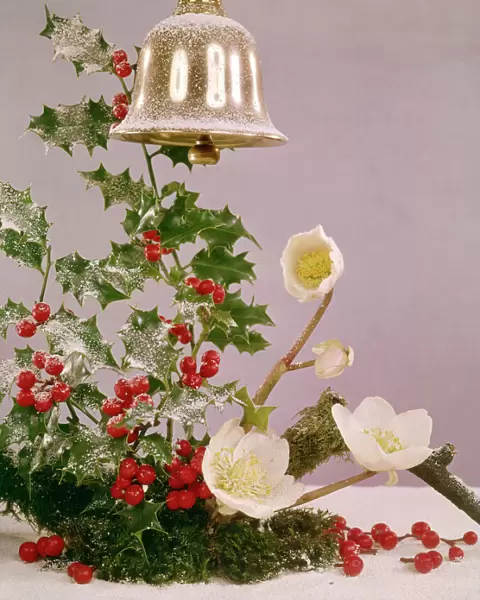 Christmas arrangement of holly, flowers and bell
