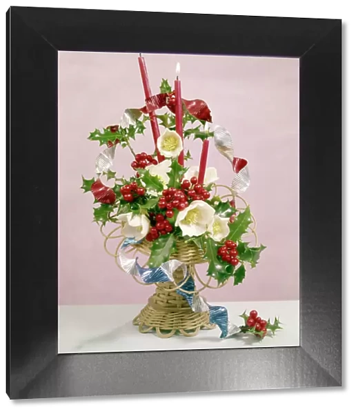 Christmas arrangement of candles, flowers and holly