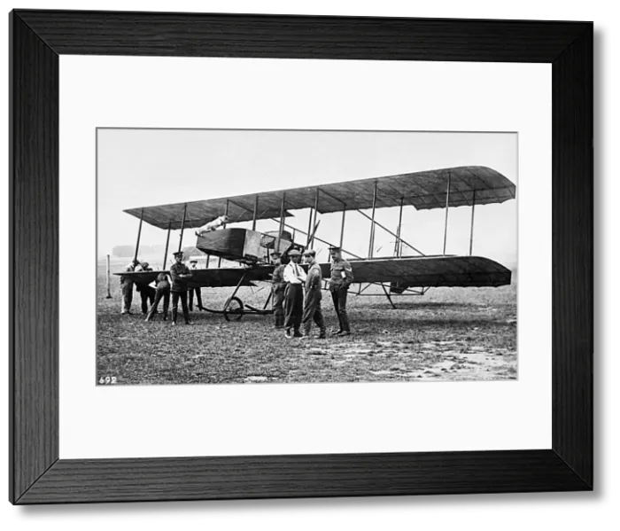 Framed Print : Men in a field with an early biplane Framed Print : Men in a field with an early biplane