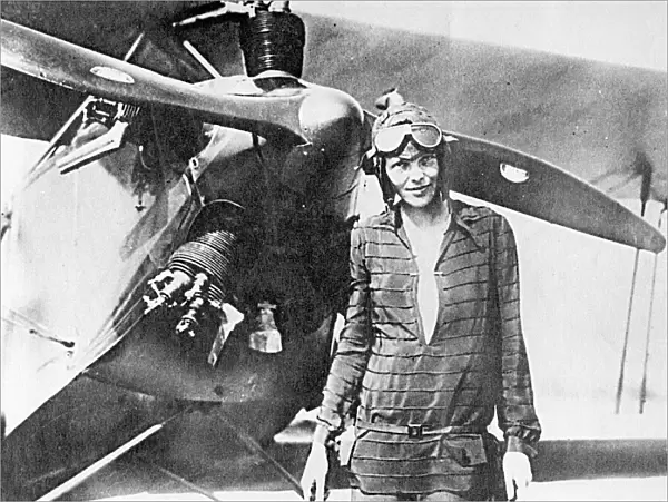Amelia Earhart, pioneering aviator, with plane