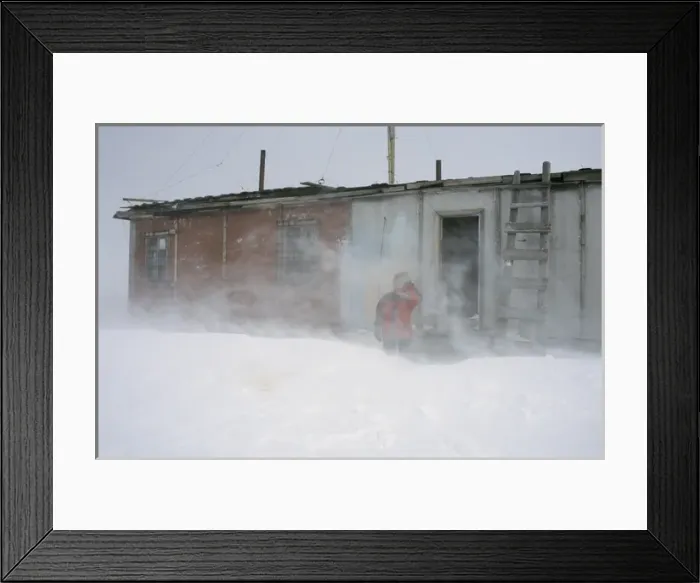 Framed Print : A researcher outside of a hut of hunters and fishermen Framed Print : A researcher outside of a hut of hunters and fishermen