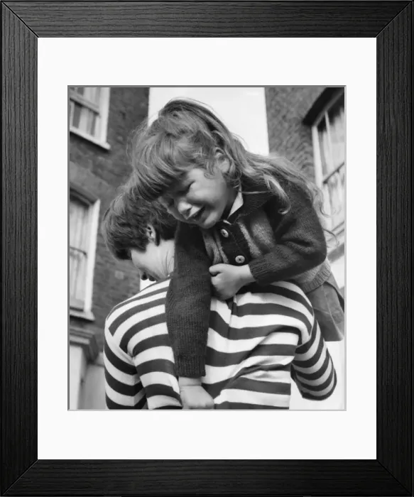 Framed Print : Little girl being carried, Balham, SW London Framed Print : Little girl being carried, Balham, SW London