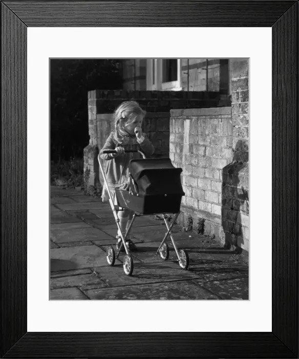 Framed Print : Girl with doll and pram, Balham, SW London Framed Print : Girl with doll and pram, Balham, SW London