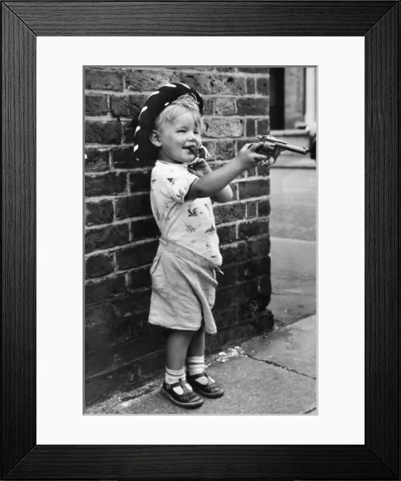 Framed Print : Boy with toy gun and cowboy hat, Balham, SW London Framed Print : Boy with toy gun and cowboy hat, Balham, SW London