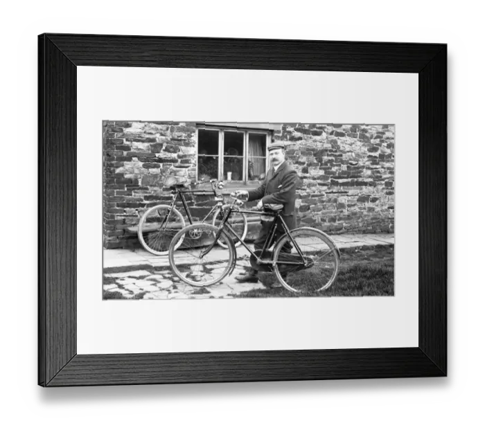 Framed Print : Man with bicycles outside house Framed Print : Man with bicycles outside house