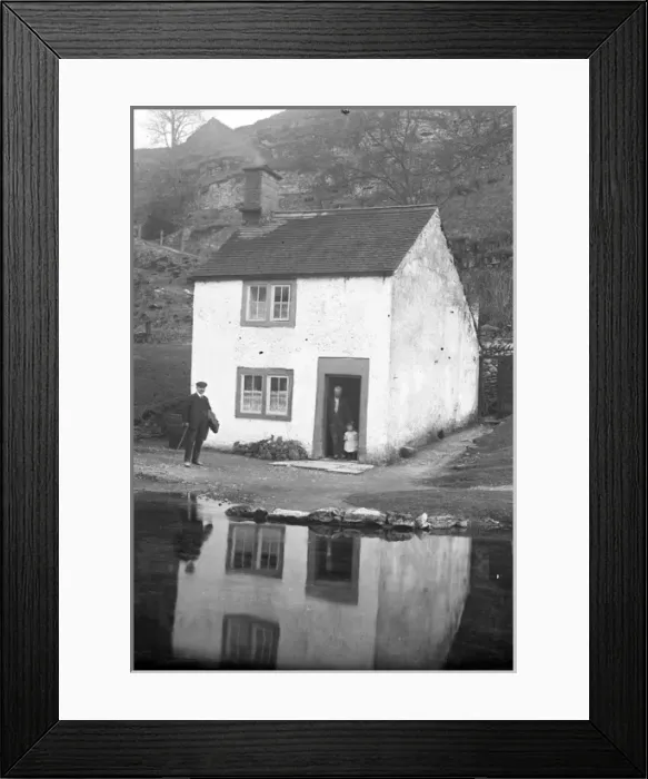 Framed Print : Man and child at door of riverside cottage in Alport, Derbys Framed Print : Man and child at door of riverside cottage in Alport, Derbys