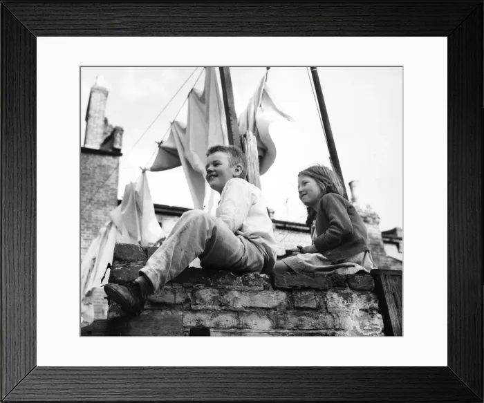 Framed Print : Boy and girl on a wall, with washing, Balham, SW London Framed Print : Boy and girl on a wall, with washing, Balham, SW London