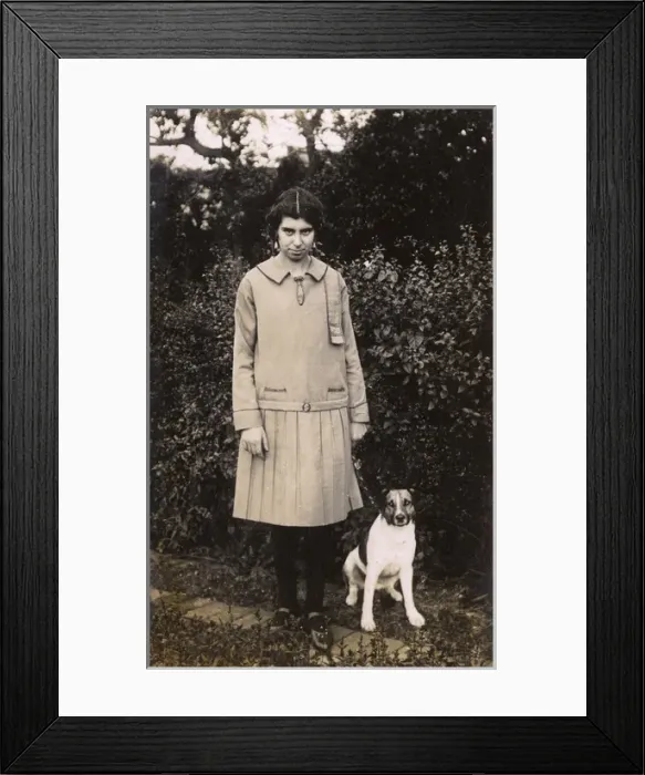 Framed Print : Woman and dog in garden Framed Print : Woman and dog in garden