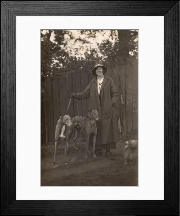 Framed Print : Woman and dogs in garden Framed Print : Woman and dogs in garden