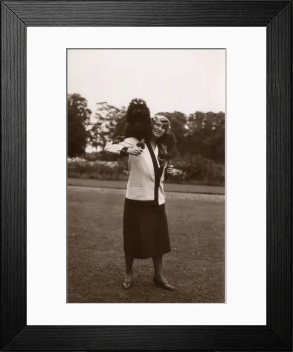 Framed Print : Woman and dog in garden Framed Print : Woman and dog in garden