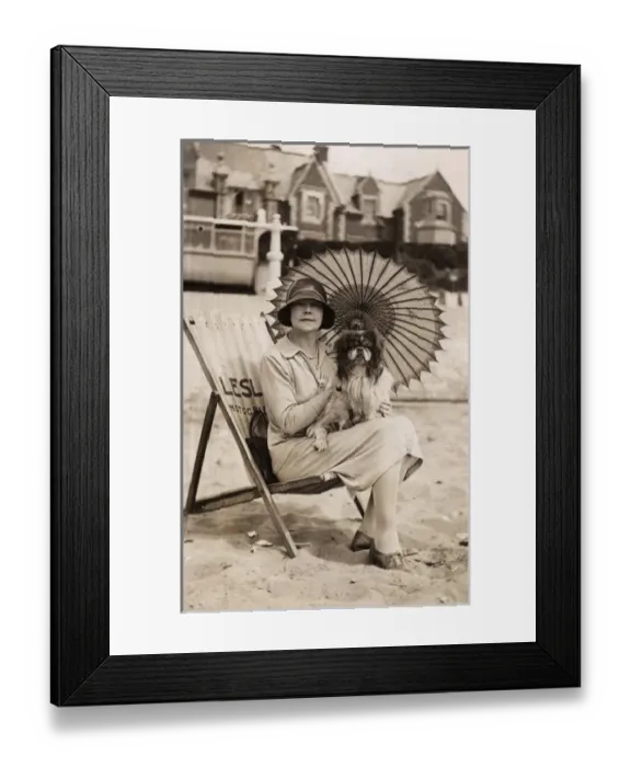Framed Print : Woman with dog and parasol on a beach Framed Print : Woman with dog and parasol on a beach