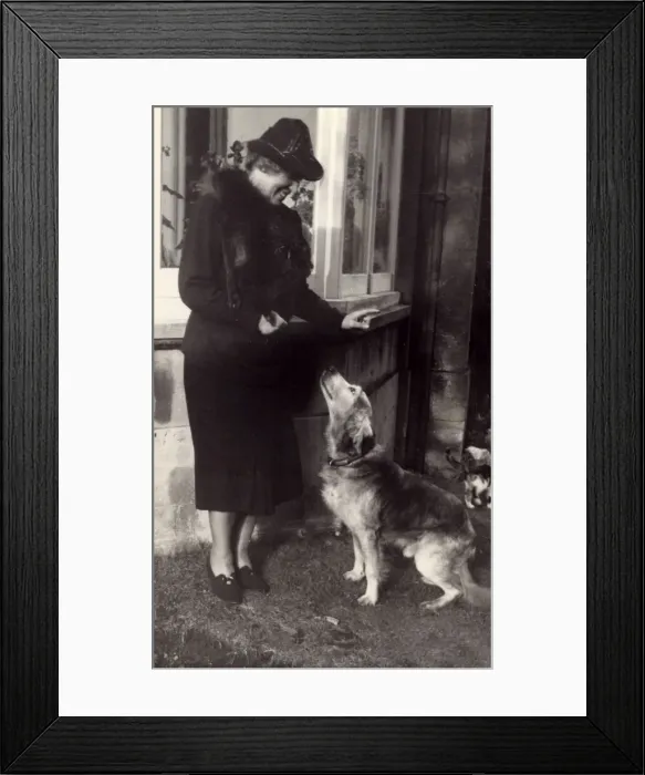 Framed Print : Woman and dog outside house Framed Print : Woman and dog outside house