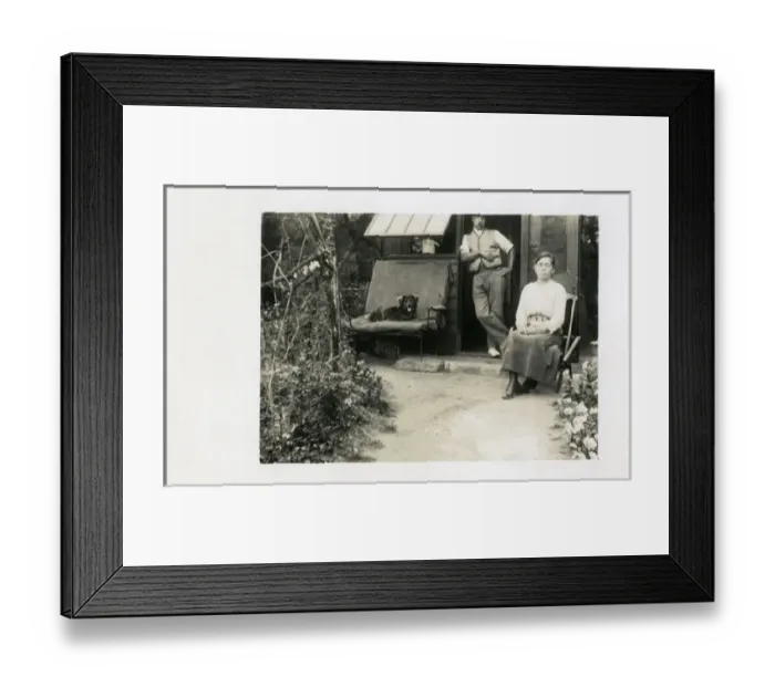 Framed Print : Middle aged couple in back yard with dog Framed Print : Middle aged couple in back yard with dog