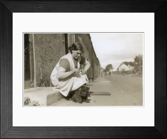 Framed Print : Young woman on doorstep with puppy Framed Print : Young woman on doorstep with puppy