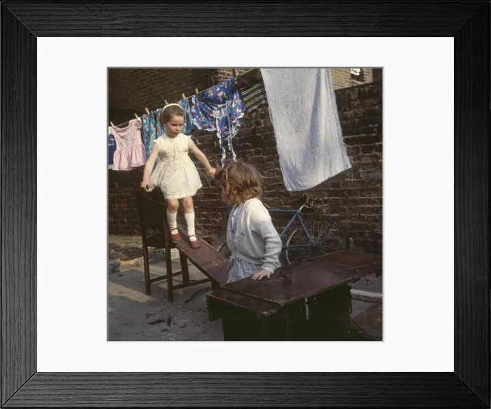Framed Print : Two girls playing with planks, Balham, SW London Framed Print : Two girls playing with planks, Balham, SW London