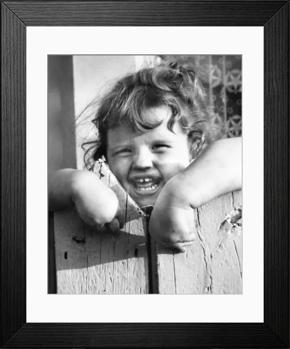 Framed Print : Little girl behind a fence, Balham, SW London Framed Print : Little girl behind a fence, Balham, SW London