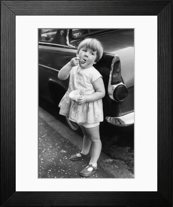 Framed Print : Girl eating ice cream on a Balham street, SW London Framed Print : Girl eating ice cream on a Balham street, SW London