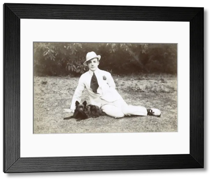 Framed Print : Young man in garden with small dog Framed Print : Young man in garden with small dog