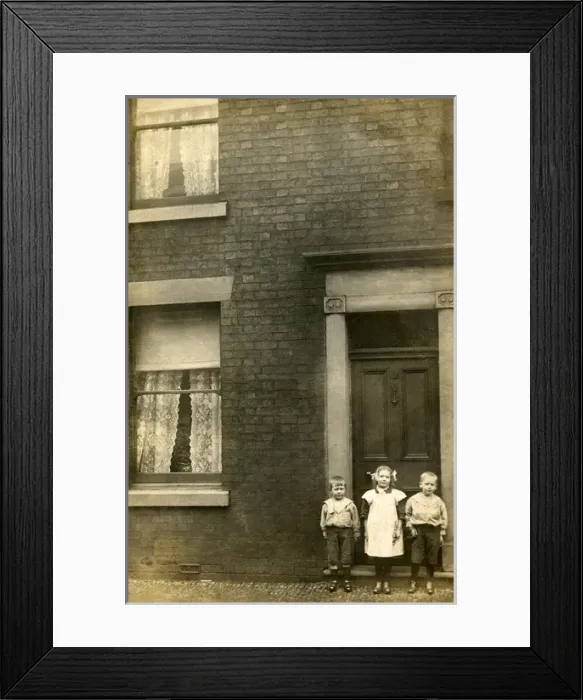 Framed Print : Three children stand outside their front door Framed Print : Three children stand outside their front door