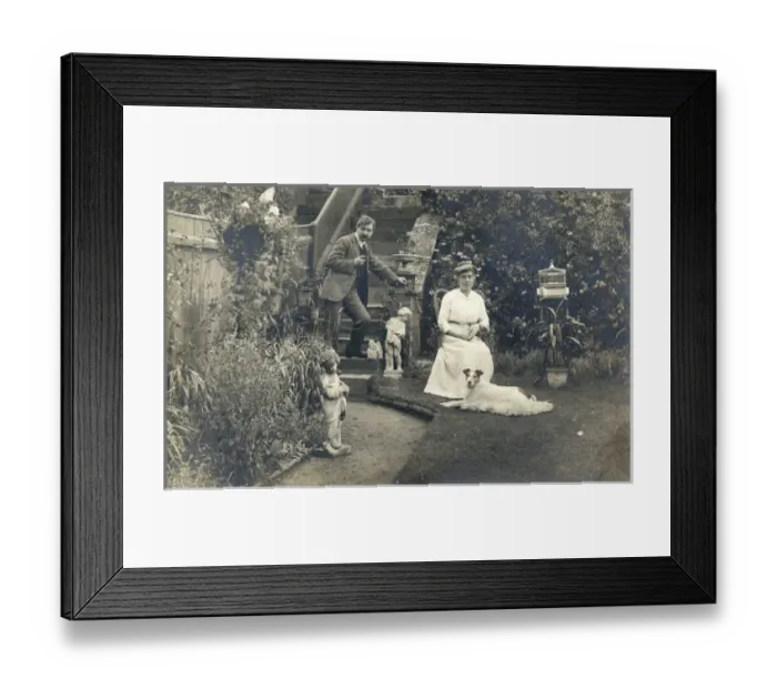 Framed Print : Middle aged couple and a dog in a garden Framed Print : Middle aged couple and a dog in a garden