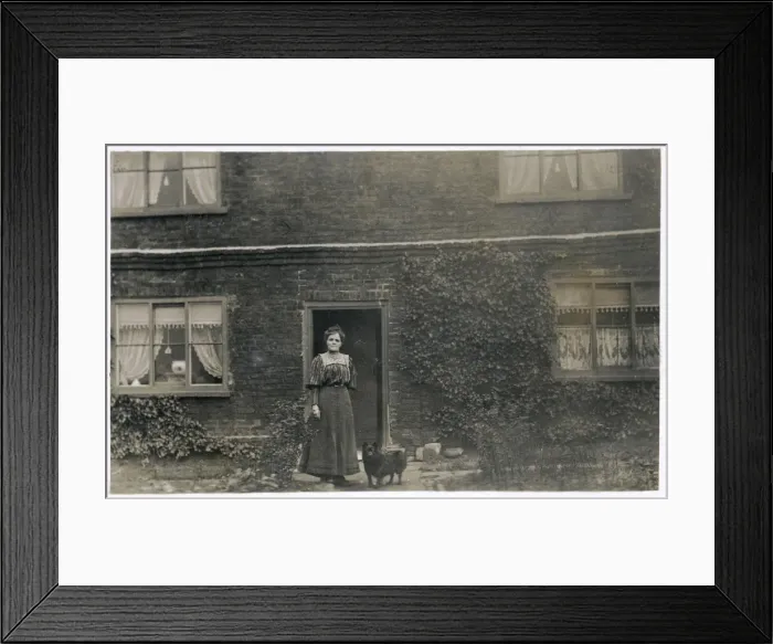 Framed Print : Woman and dog outside a farnhouse Framed Print : Woman and dog outside a farnhouse
