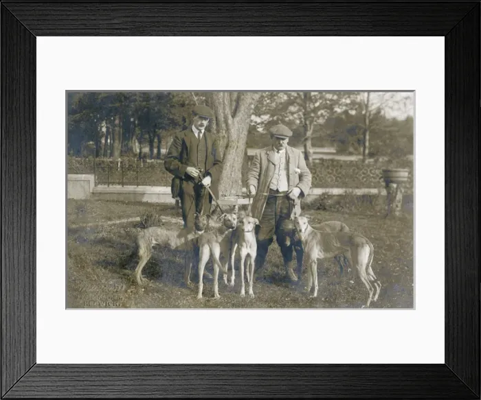 Framed Print : Two men with five dogs in a garden Framed Print : Two men with five dogs in a garden