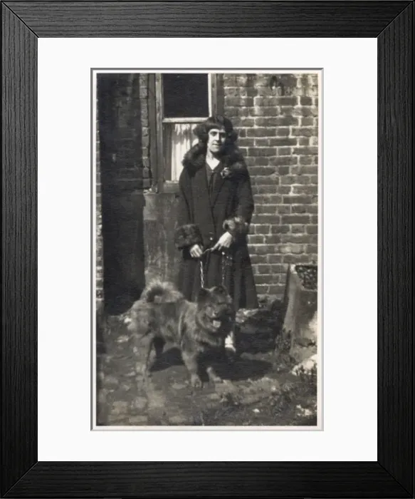 Framed Print : Woman with a dog outside a house Framed Print : Woman with a dog outside a house