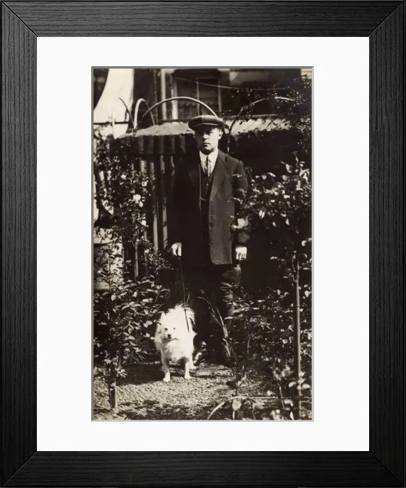 Framed Print : Man with a dog in a garden Framed Print : Man with a dog in a garden