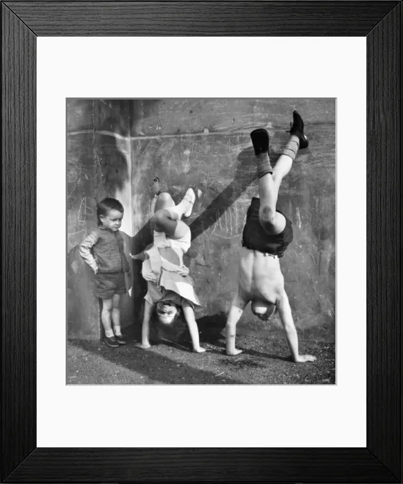Framed Print : Children doing handstands on a Balham street, SW London Framed Print : Children doing handstands on a Balham street, SW London
