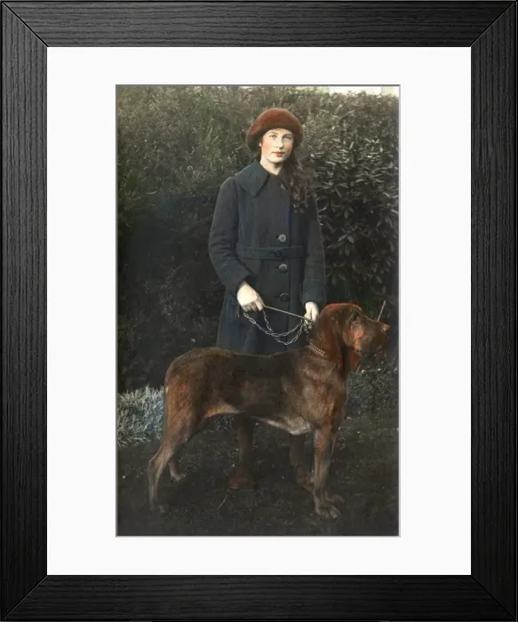 Framed Print : Young woman with a dog in a garden Framed Print : Young woman with a dog in a garden