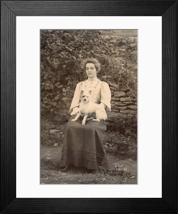Framed Print : Young woman with a terrier in a garden Framed Print : Young woman with a terrier in a garden