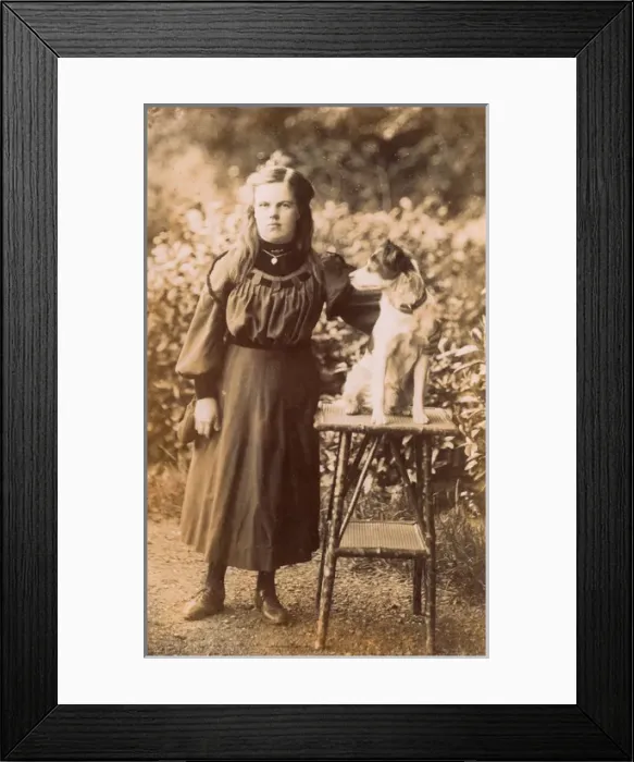 Framed Print : Young woman with a terrier in a garden Framed Print : Young woman with a terrier in a garden