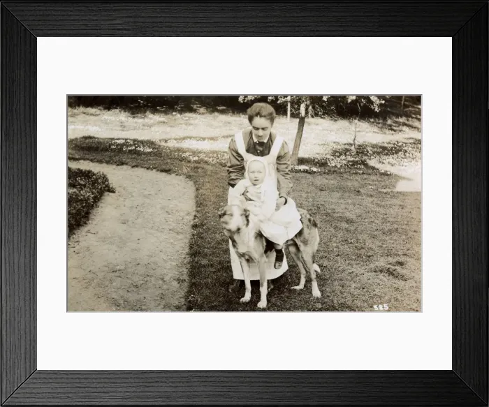 Framed Print : Nanny taking baby for a ride on a large dog Framed Print : Nanny taking baby for a ride on a large dog