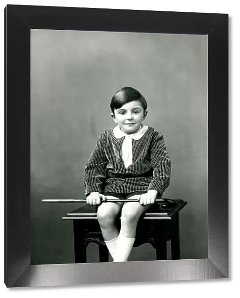 Little boy sitting on a stool