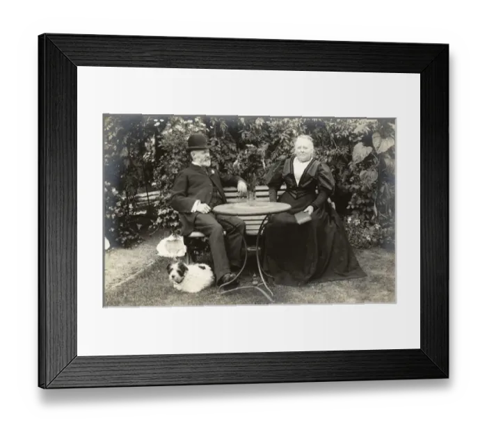 Framed Print : Middle aged couple and a dog in a garden Framed Print : Middle aged couple and a dog in a garden