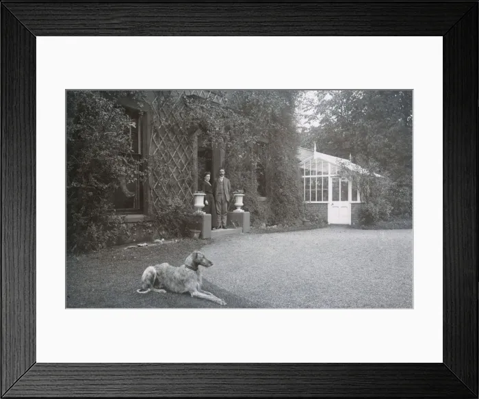 Framed Print : Couple in doorway with a dog Framed Print : Couple in doorway with a dog