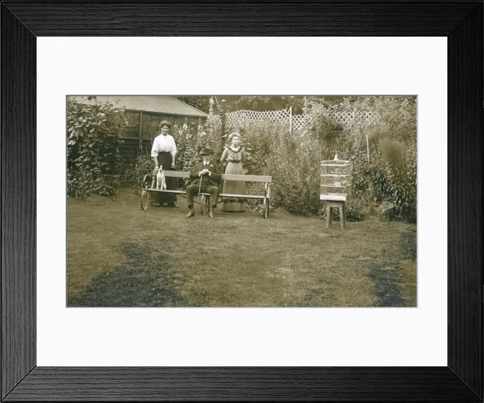 Framed Print : Three people with a dog in a garden Framed Print : Three people with a dog in a garden