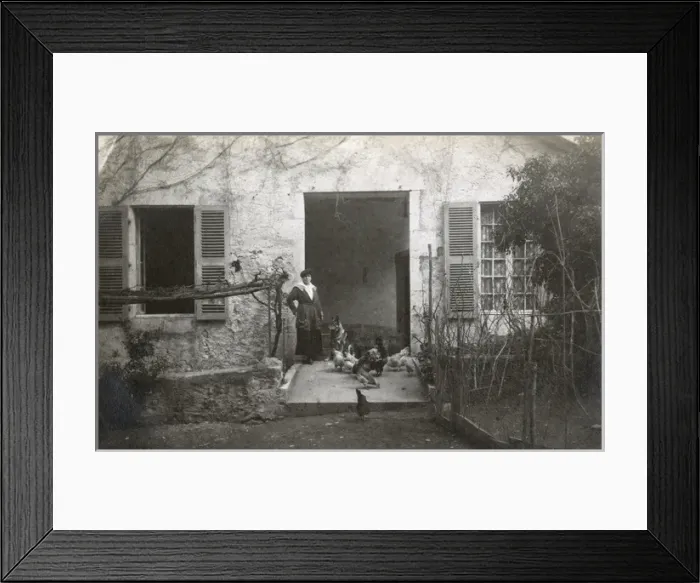 Framed Print : Woman with a dog and chickens in a garden, France Framed Print : Woman with a dog and chickens in a garden, France